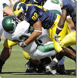 (caption) Michigan defensive tackle Greg Banks (92) clobbers Eastern Michigan running back Dominique Sherrer after a one-yard gain in the fourth quarter. *** Michigan defeated Eastern Michigan 45-17 at Michigan Stadium in Ann Arbor, rushing for 380 yards, but passing for just 68 yards. Photos taken on Saturday, September 19, 2009. ( John T. Greilick / The Detroit News )



