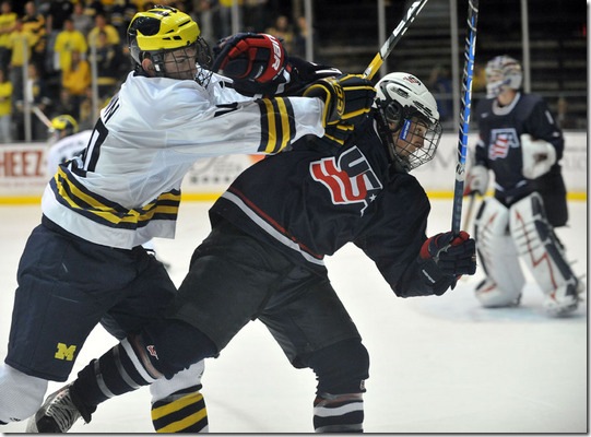 University of Michigan's Chris Brown checks U.S. National Under-18's Justin Faulk in the third period at Yost Arena on Oct 3, 2009.  U-M won the exhibition opener, 4-2.  (Mark Bialek for AnnArbor.com)