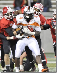 Howland running back #4 DeVeon Smith is tackled by a pack of Kent Roosevelt Roughriders.