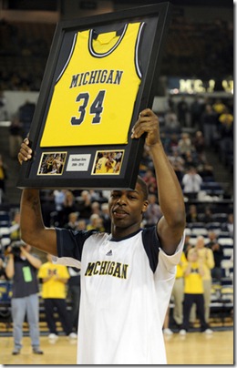 Michigan's DeShawn Sims holds up a framed game jersey as he and fellow seniors Zack Gibson and Anthony Wright were recognized before their final game at Crisler Arena. The seniors went out winners with a 83-55 trouncing of Minnesota, Tuesday night March 2nd. 
Lon Horwedel | AnnArbor.com
