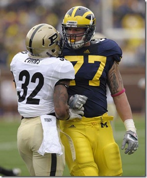 (CAPTION INFORMATION)
Michigan offensive linesman Taylor Lewan and Purdue safety Albert Evans have words after a play.  Lewan was given a penalty for his troubles.               Photos are of the University of Michigan vs. Purdue University at Michigan Stadium in Ann Arbor, October 29, 2011.   (David Guralnick / The Detroit News)
