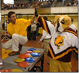Jason Cook, a member of Ferris State University's Rube Goldberg team the Underdogs, pauses from his work to give a high-five to Ferris State's mascot, Brutus the bulldog. The Underdogs, from Big Rapids, Mich., finished second today (Saturday, 4/3) in the National Rube Goldberg Machine Contest at Lambert Fieldhouse. (Purdue News Service photo/Dave Umberger)

rubenat04-ferris.jpg

