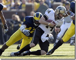 (CAPTION INFORMATION)
Purdue's Joey Elliott is sacked by Michigan's Al Backey in the first quarter.         Photos are of the University of Michigan vs. Purdue University at Michigan Stadium, November 7, 2009.    (The Detroit News / David Guralnick)
