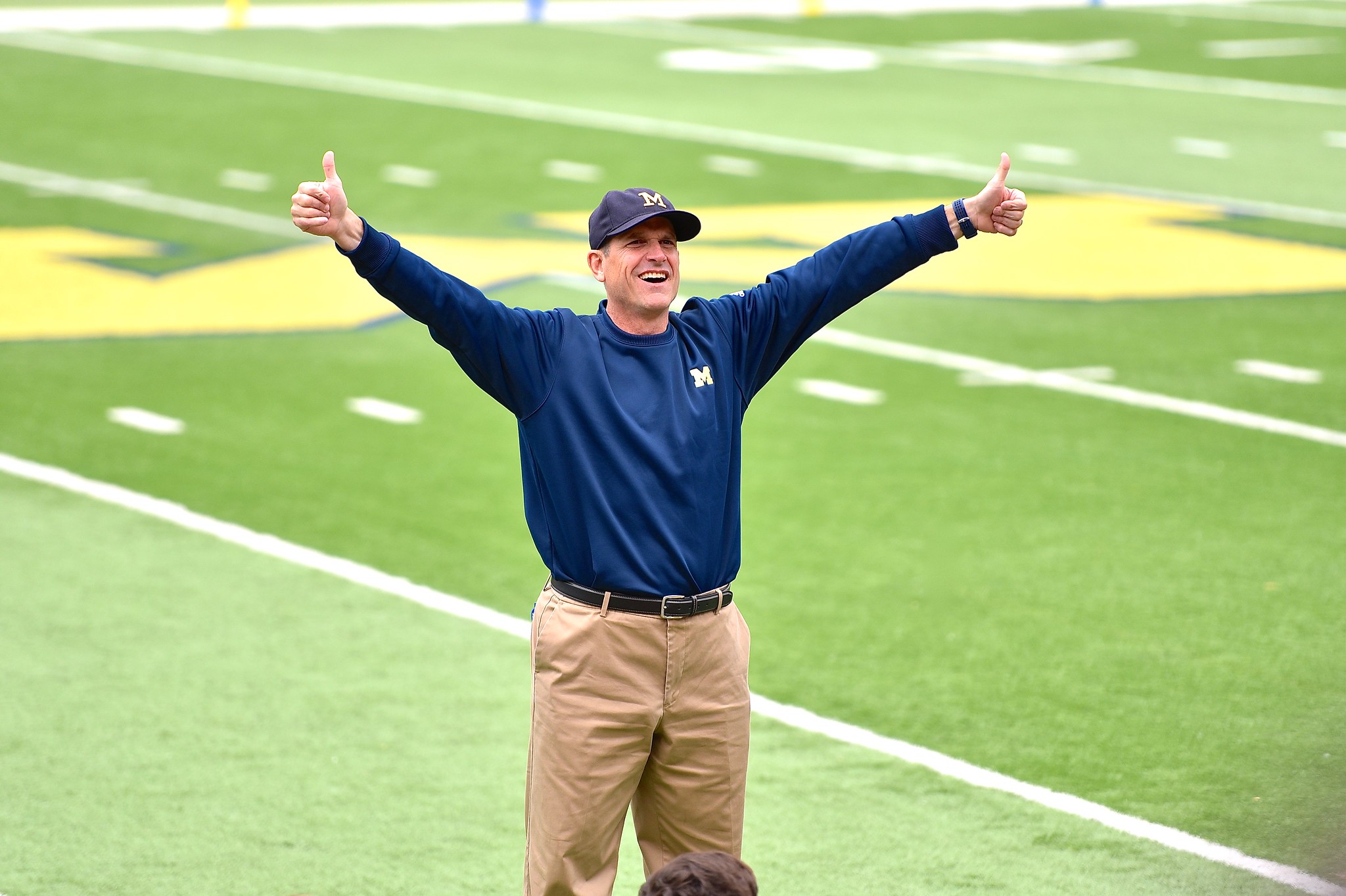 Jim Harbaugh surveys campers at the Ann Arbor Aerial Assault camp