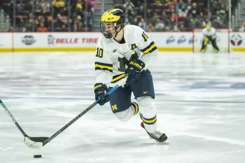 Will Lockwood skates the puck up against Michigan State