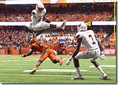 Sep 9, 2016; Syracuse, NY, USA; Louisville Cardinals quarterback Lamar Jackson (8) leaps over Syracuse Orange defensive back Cordell Hudson (20) during the second quarter at the Carrier Dome. Mandatory Credit: Rich Barnes-USA TODAY Sports
